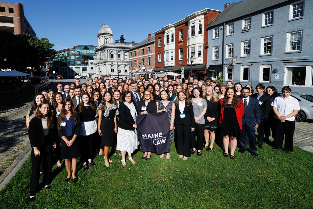 Photo of the class of 2026 standing outside the Maine Law Building