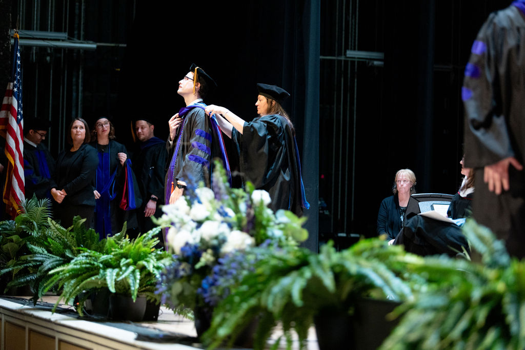 Photo of a student at graduation being hooded.