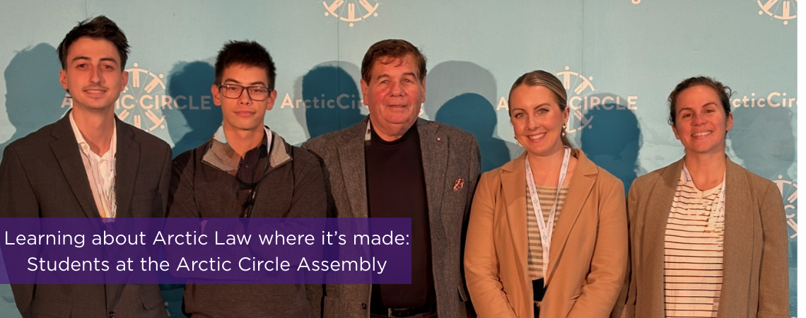 Photo of faculty and students standing in front of a sign that reads "Arctic Assembly"